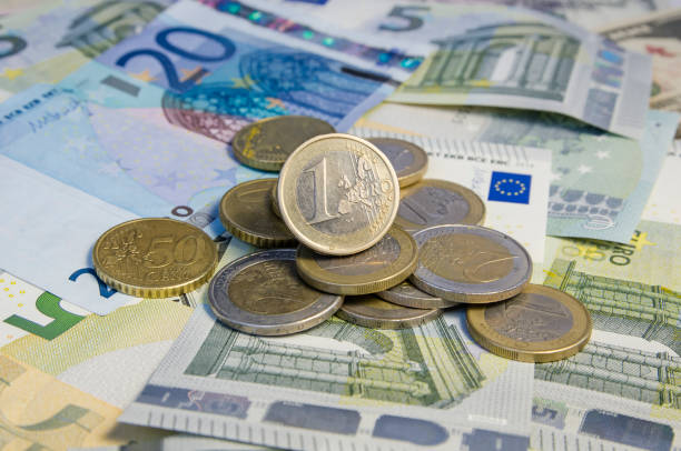istock Russian roubles coins and Euro coins on banknotes. 868346140