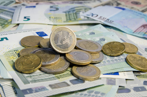 istock Russian roubles coins and Euro coins on banknotes. 868346186