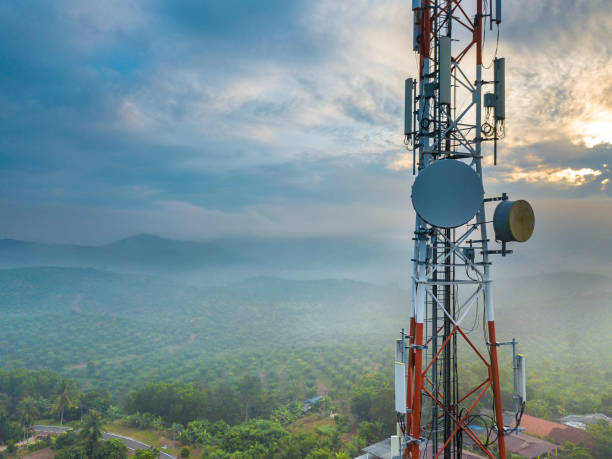 Aerial photography Aerial view of telecommunication tower with sunrise background. tower stock pictures, royalty-free photos & images