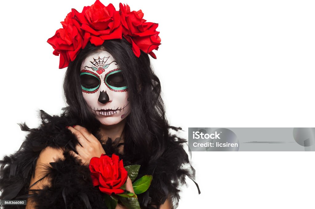 Day of the dead. Halloween. Young woman in day of the dead mask skull face art and rose. Isolated on white. closeup Young woman in day of the dead mask skull face art and rose 20-29 Years Stock Photo