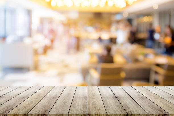 istock Empty wood table top with restaurant blur bokeh background - can be used for display your products. 868370528