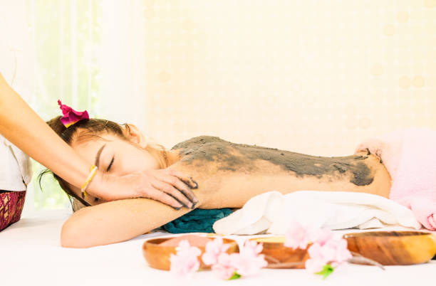 istock Woman is receiving Spa Charcoal Scrub in Thai Spa 868373656