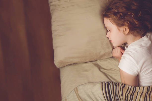 istock Cute curly girl is sleeping. 868373910