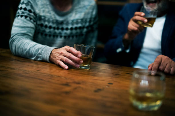 istock Two friends having a drink together 868380752