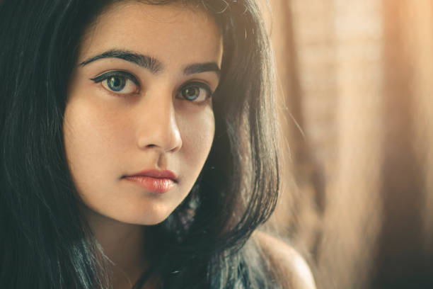 istock Beautiful young woman looking at camera. 868385634