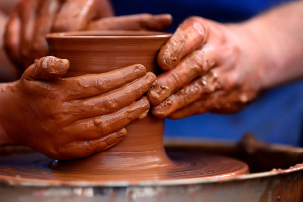 istock Potter making ceramic pot on the pottery wheel 868389244