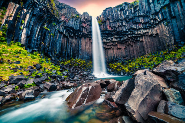 istock Dramatic morning view of famous Svartifoss (Black Fall) Waterfall. 868392948