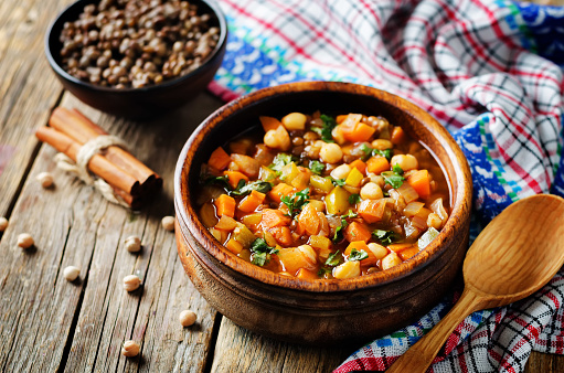 Moroccan spicy green lentils chickpea soup on a wood background. toning. selective focus