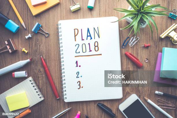 Plan 2018 Message With Notepad Paper On Wooden Table Stock Photo - Download Image Now