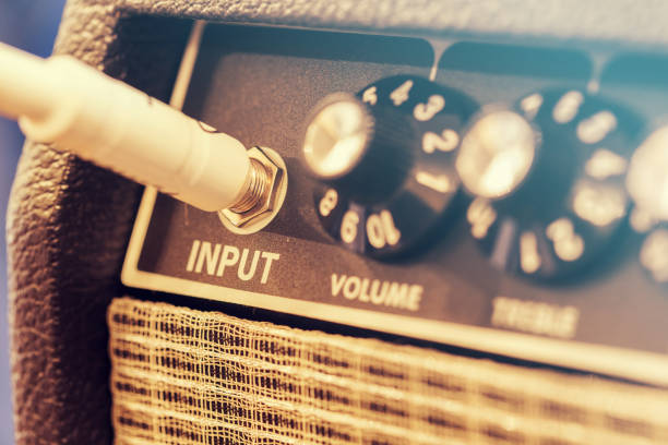 Guitar Amplifier Close-up of switches on music amplifier, vintage amplifier plug stock pictures, royalty-free photos & images
