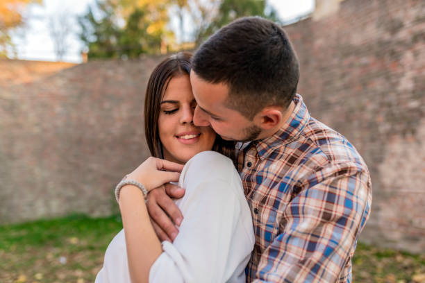 istock Young couple enjoying in park in autumn. 868404694