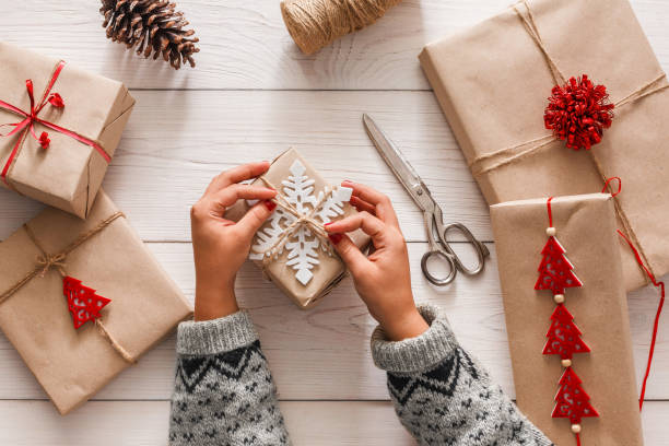 istock Woman's hands wrapping christmas holiday present with craft twine 868408908