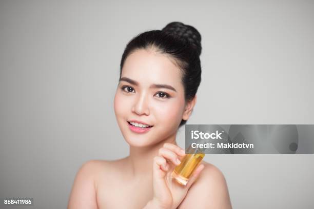 Beauty Concept Asian Pretty Woman With Perfect Skin Holding Oil Bottle Stock Photo - Download Image Now