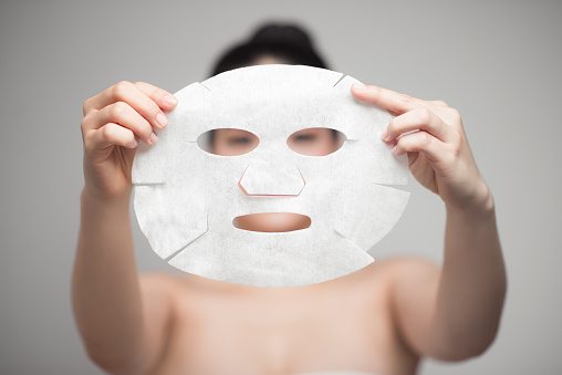 Spa, healthcare. Asian girl with a cosmetic mask.