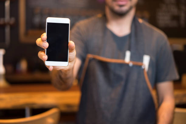 istock Barista showing smartphone screen 868413900
