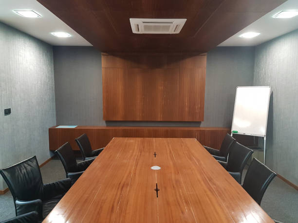 istock empty meeting room with wooden table gray walls 868418946