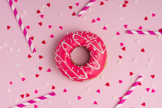 istock Donuts with icing on pastel pink background with copyspace. Sweet donuts. 868421426