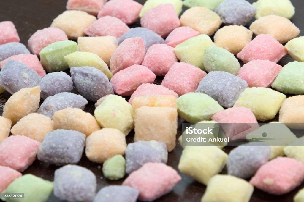 A lot of colorful candy. A lot of colorful candy. Close up macro, on wooden table. Candy Stock Photo
