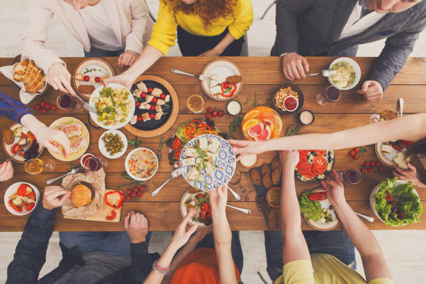 istock People eat healthy meals at served table dinner party 868422702