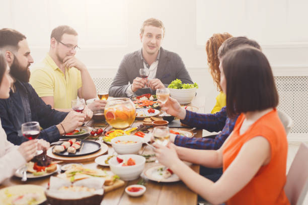 istock Group of people drink wine at festive table dinner party 868425566