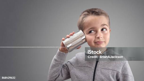 Tin Can Phone Listening To Curious Good News Stock Photo - Download Image Now - Listening, Child, Communication