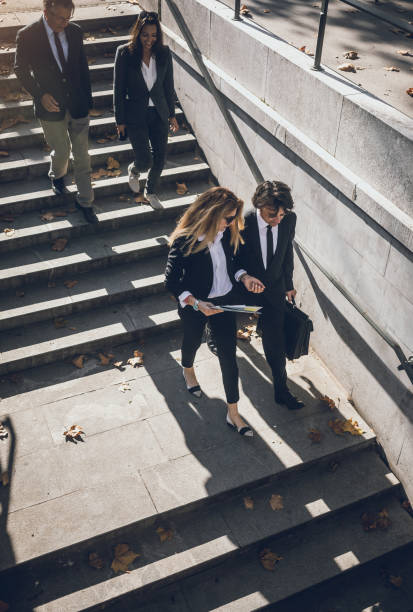 istock Business People Walking Down The Stairs 868433462