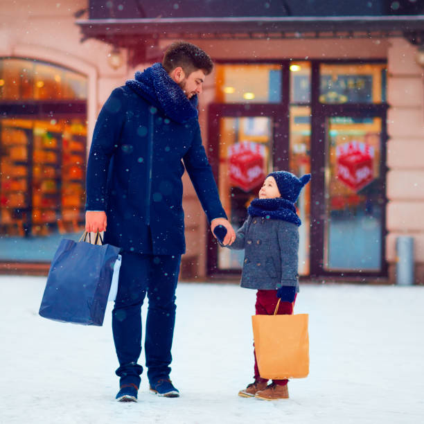 istock happy father and son shopping during winter holidays 868434108