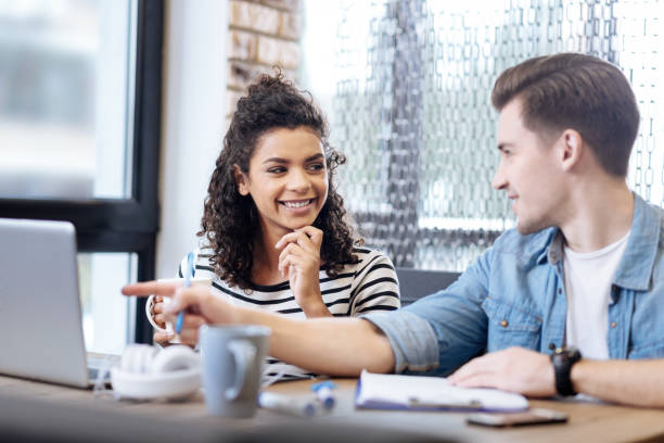 istock Delighted girl and boy sitting and working together 868434290