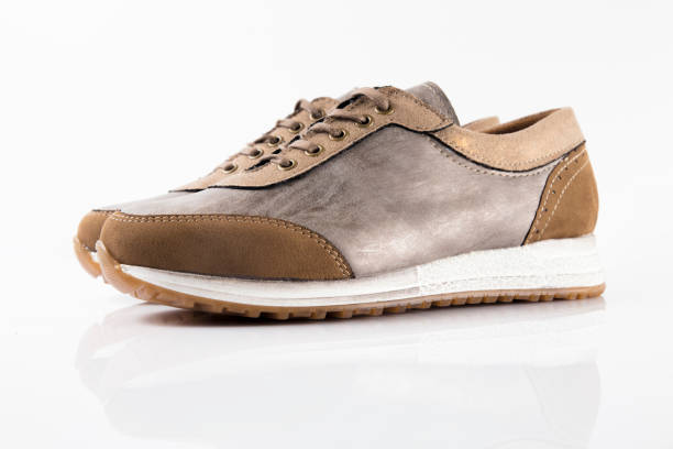 istock Female Brown leather sneaker on white background. 868436608