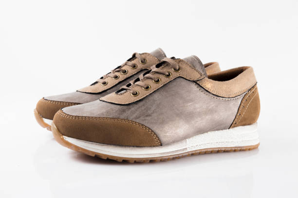 istock Female Brown leather sneaker on white background. 868436768
