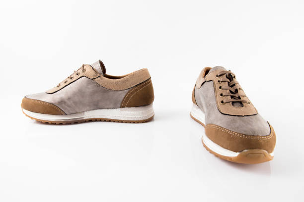 istock Female Brown leather sneaker on white background. 868436850
