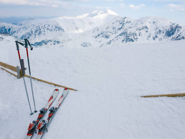 istock Snow covered mountains and alpine skis on a foreground 868437430