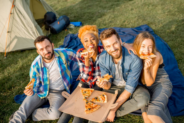 istock Friends eating pizza at the camping 868438052