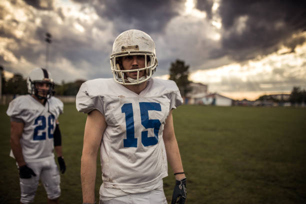 Rear view of American football player against white background