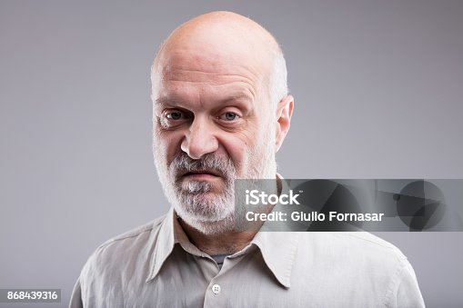 istock old bald man disgusted and disappointed 868439316