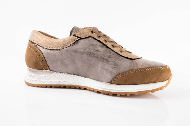 istock Female Brown leather sneaker on white background 868441668