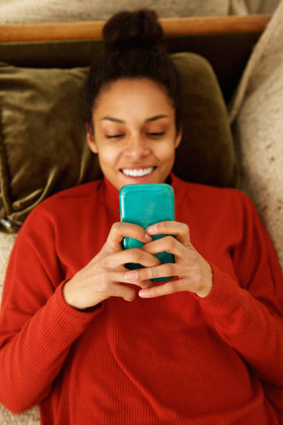 istock Attractive young woman smiling with smart phone 868441688