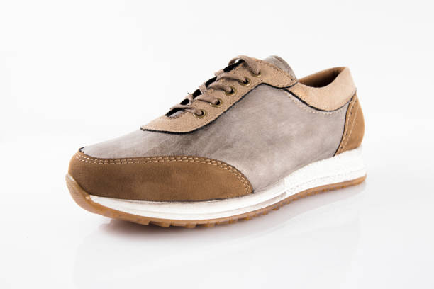 istock Female Brown leather sneaker on white background 868441698