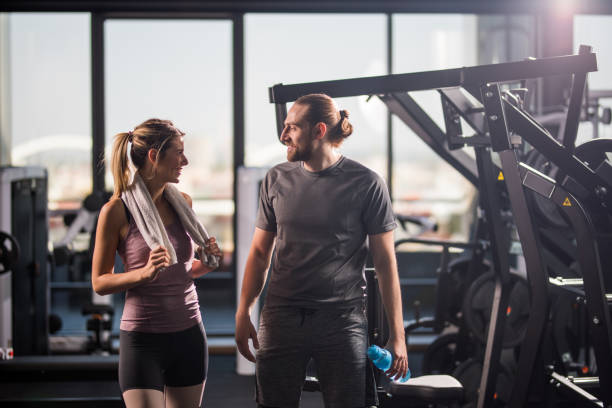 istock Happy athletic couple communicating on a break in a gym. 868441822