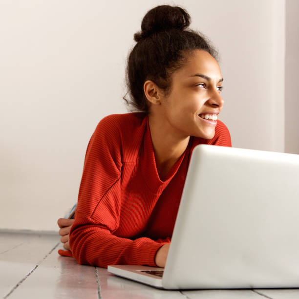 istock Smiling young attractive woman relaxing with laptop 868441944