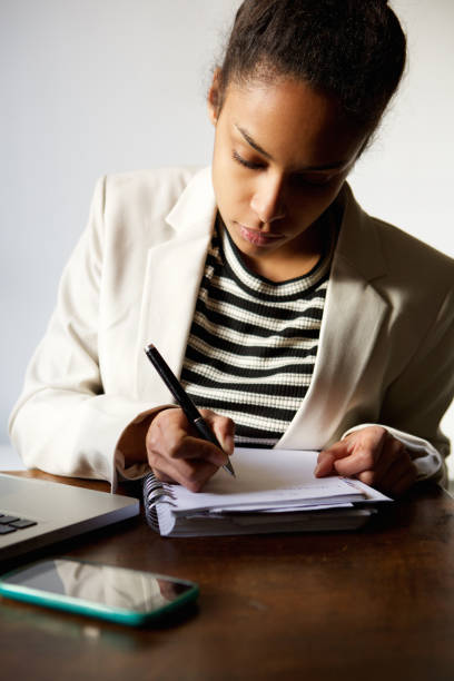 istock Serious young business woman taking notes 868442168