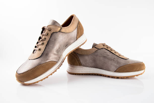 istock Female Brown leather sneaker on white background 868442292