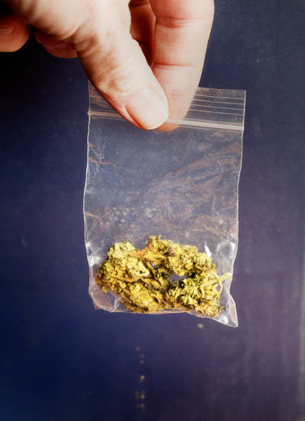 istock Hand holding bank bag of cannabis 868442432