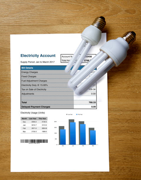 istock Top view of electricity account bill with two light bulbs. 868446448
