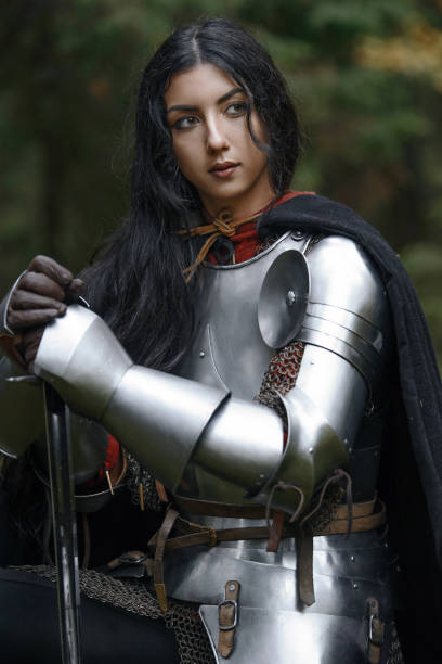 istock A beautiful warrior girl with a sword wearing chainmail and armor in a mysterious forest. 868450030