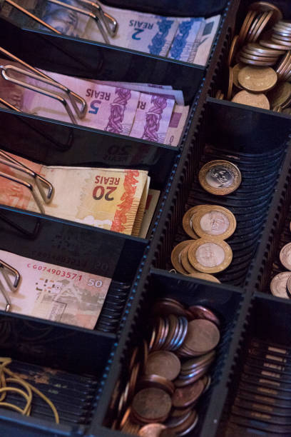 istock Brazilian money notes and coins inside the electronic cash register 868451484