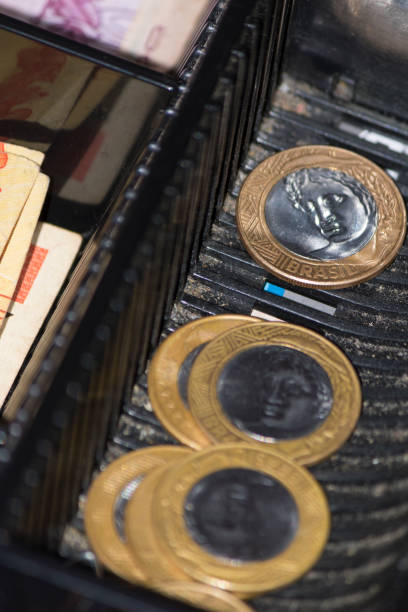istock Brazilian money notes and coins inside the electronic cash register 868451490