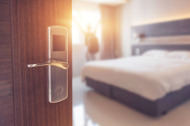Opened door of hotel room in morning Opened door of hotel room in morning with background blurred happy backpacker traveller stay in hotel, copy space, sunlight effect. hotel suite photos stock pictures, royalty-free photos & images