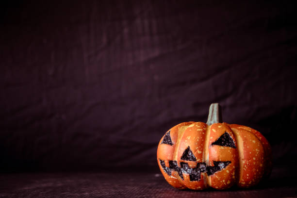 istock Halloween pumpkin on a black background. Vintage tone. Free space for text 868453928
