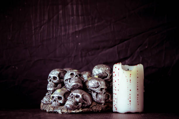 istock Skulls and candle  on a black background. Vintage tone. 868453970